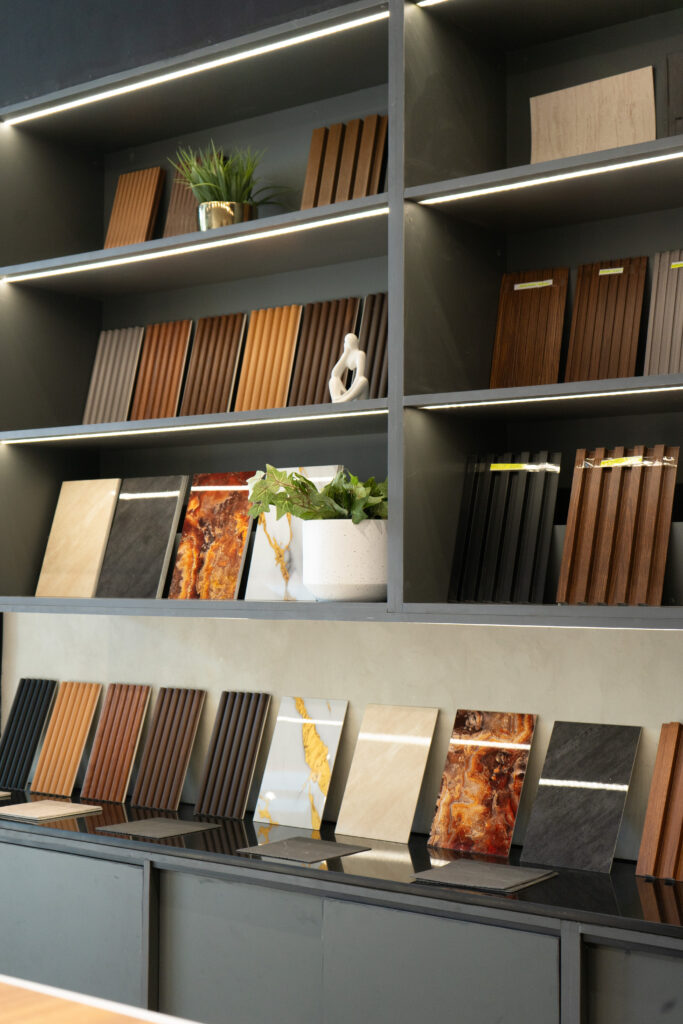 Flame & Finish showroom interior with sample islands and a branded wall in view.