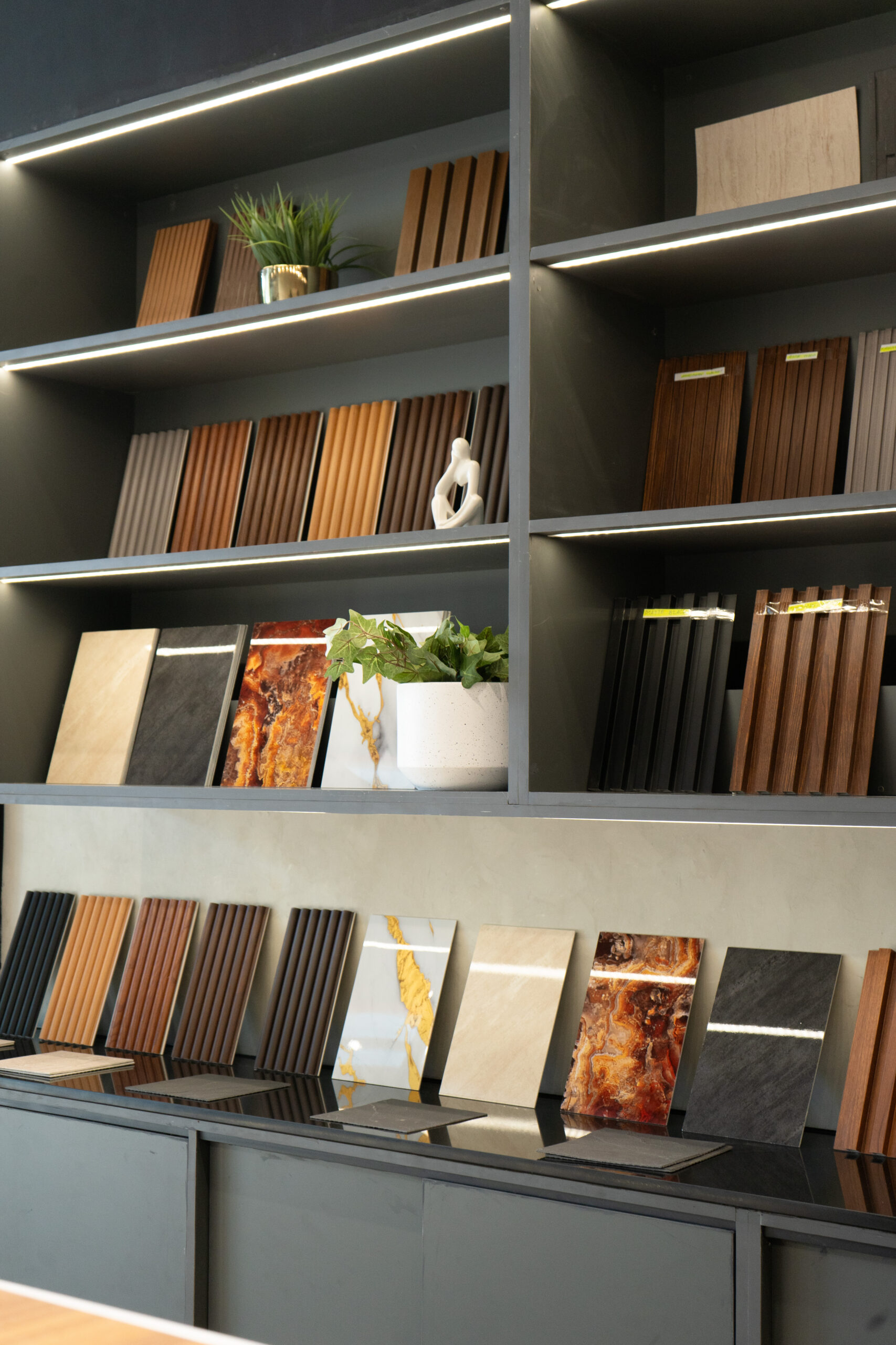 Flame & Finish showroom interior with sample islands and a branded wall in view.
