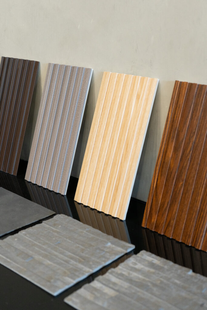 Branded logo wall with tabletop material samples in the Flame & Finish showroom.