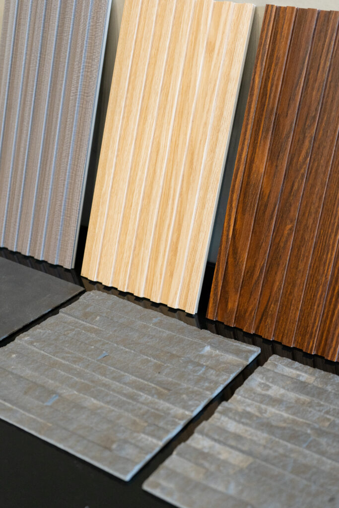 Selection of wood-look and stone-look floor samples arranged for display.