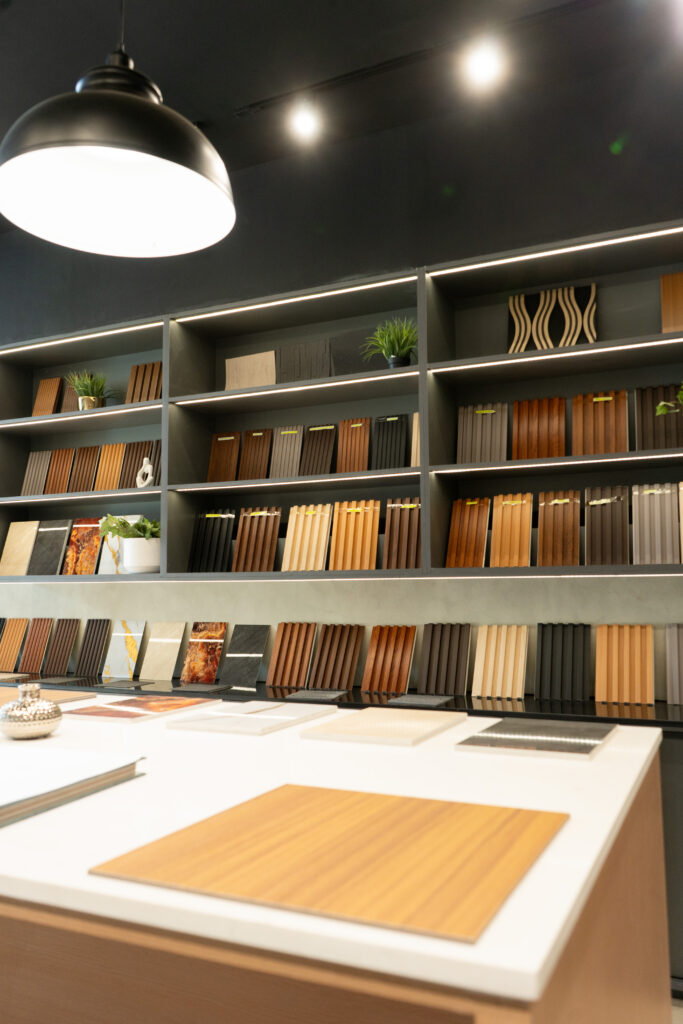 Sample island and lit material wall inside the Flame & Finish showroom in Cebu.